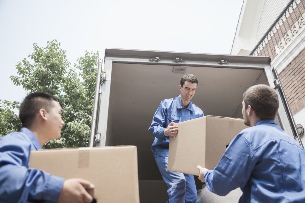 workers loading moving truck with boxes