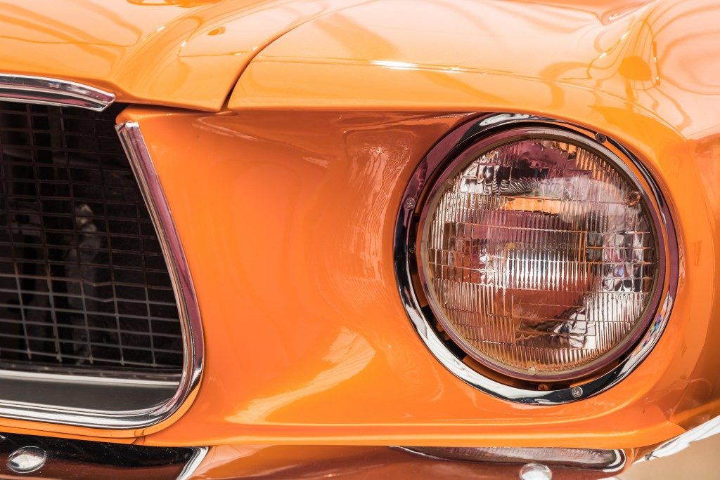 orange car, zoom in on headlights