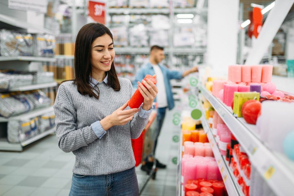Couple choosing candles in supermarket, shopping