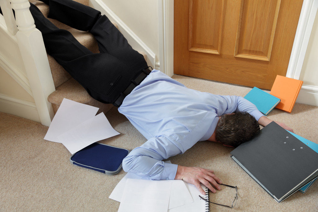 Business man falling down the stairs in the office concept for accident and insurance injury claim at work