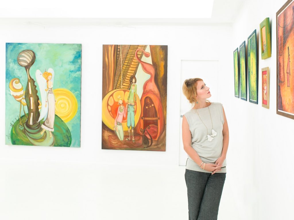 woman looking at paintings