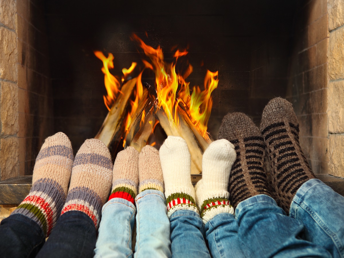 wearing socks infront of a fireplace