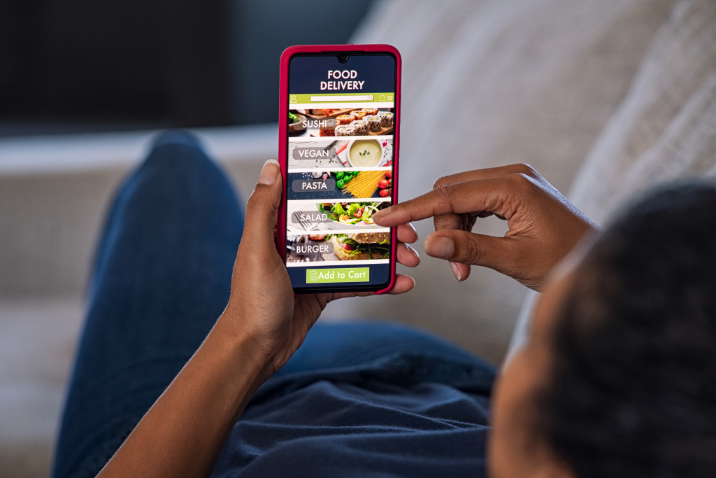 woman scrolling through food delivery app