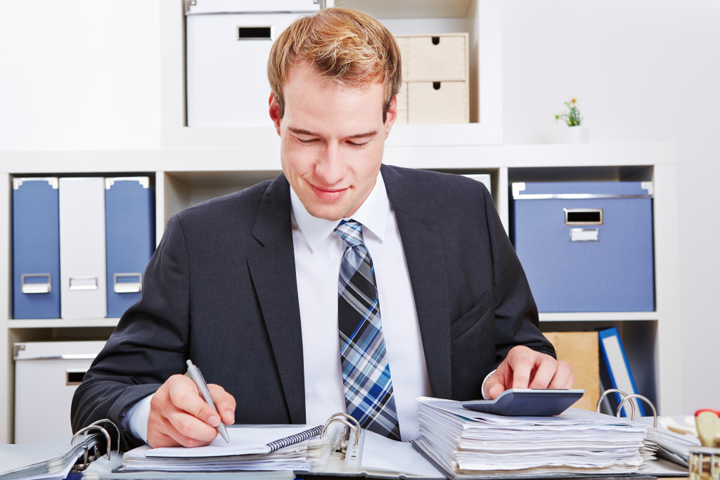 male accountant smiling while working